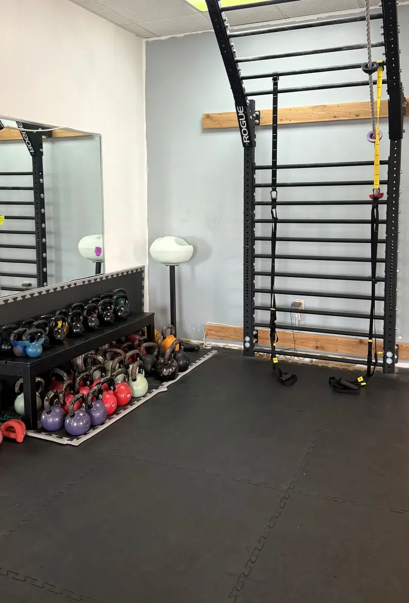 Kettlebell rack and stall bars ready for a private session at Sidekick Strong
